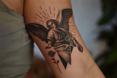 Some rare guardian angel tattoos depict a female angel looking after a child or two children who are clinging to her garment for protection while she guides them to safety. . Guardian angel tattoos female